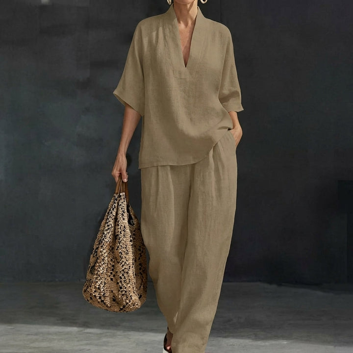 Full-body view of a women's relaxed V-neck top & wide-leg pants set. Matching two-piece outfit for casual style.