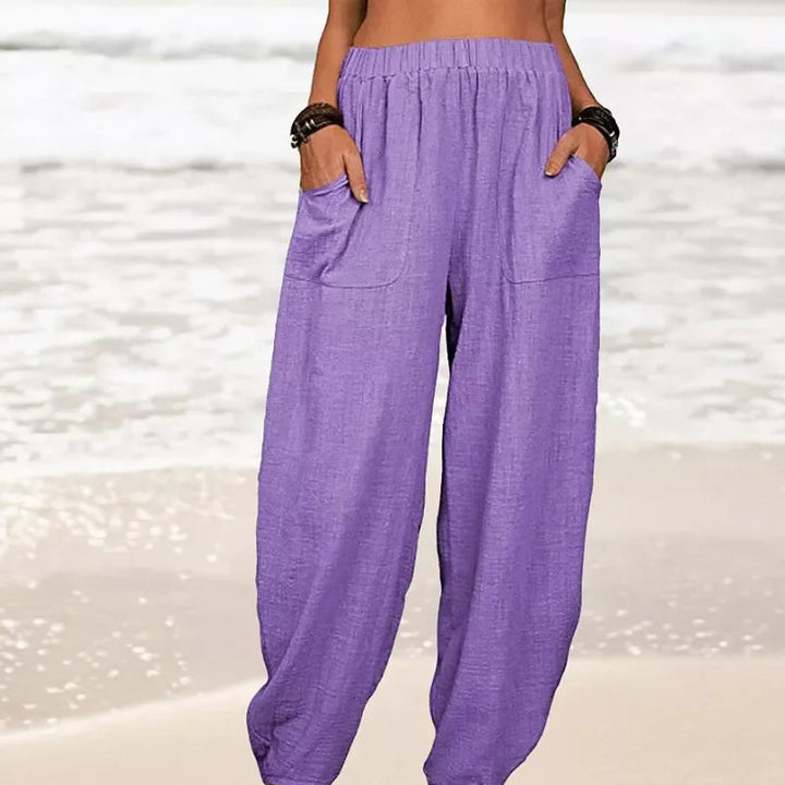 Model showcasing women's relaxed wide-leg beach pants, perfect for summer strolls & holidays.