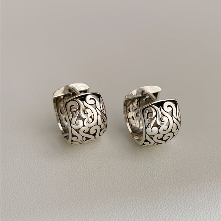 Women's Relic sterling silver hoop earrings with intricate engraving, antique finish, and secure clasp.