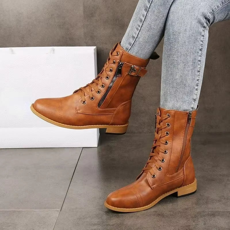 Black women's mid-calf lace-up boots featuring stylish buckles for an edgy look.