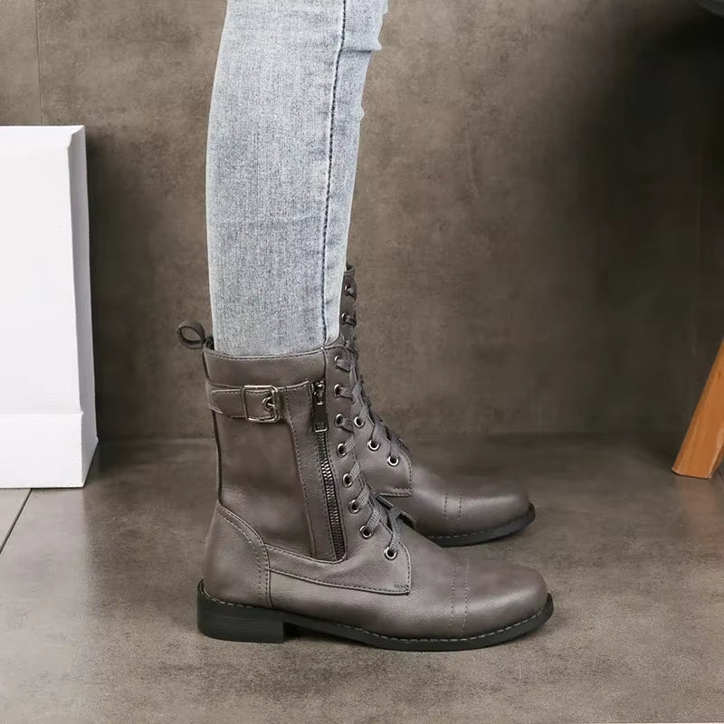 Women's mid-calf combat boots with decorative buckles, side zipper, and lace-up front.