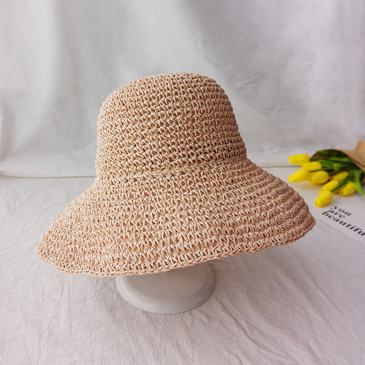 Woman wearing a chic flat-brim women's hat, ideal for summer beach outfits