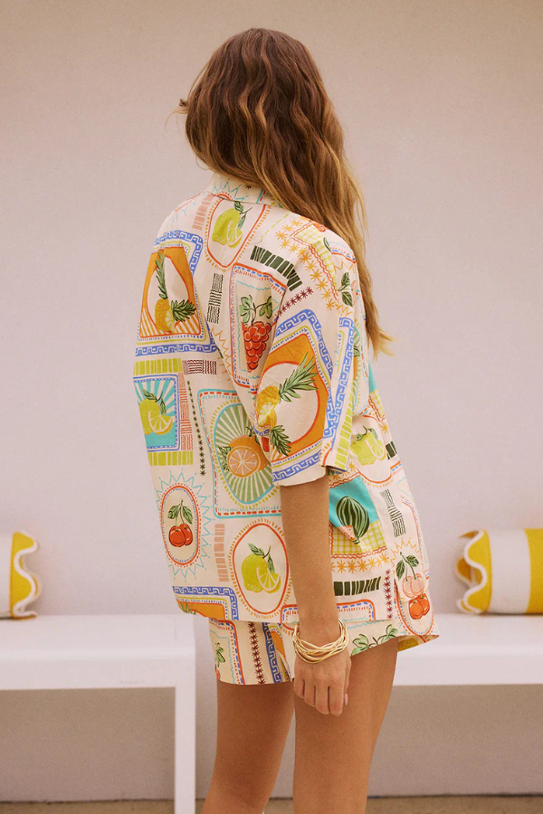 Stylish women's short sleeve top and matching shorts summer set, featuring a fun retro fruit pattern. Summer fashion.