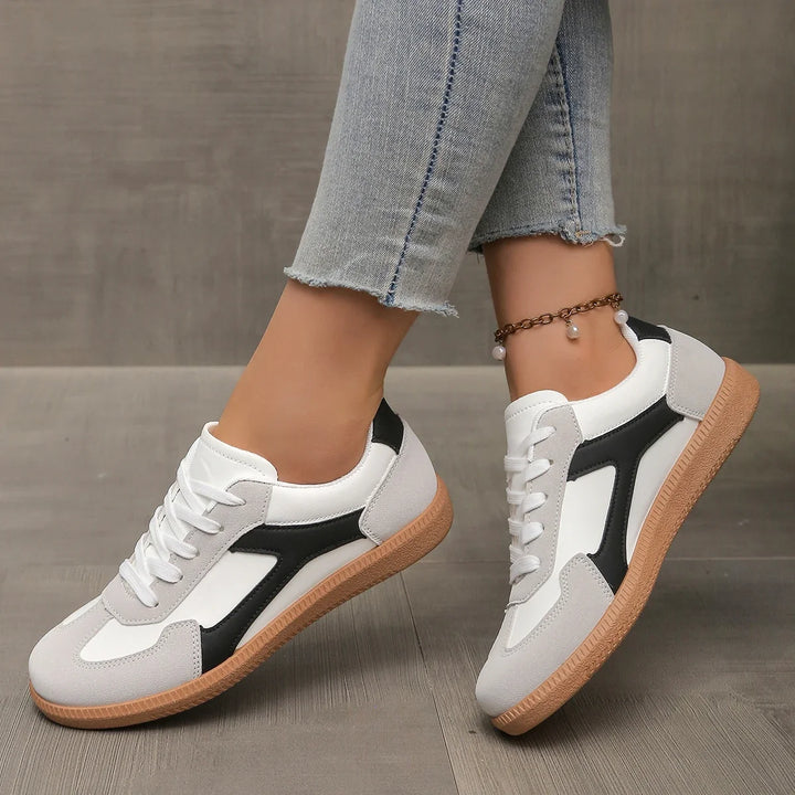 Classic women's lifestyle sneakers with a retro, low-profile design. Comfortable and stylish everyday footwear.