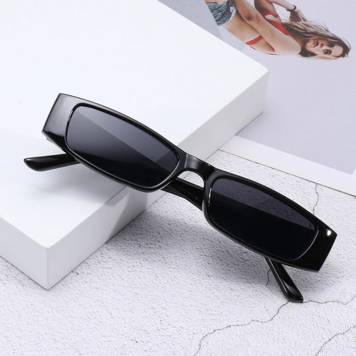 Black women's retro slim rectangular sunglasses, polycarbonate frame, chic 90s fashion accessory.