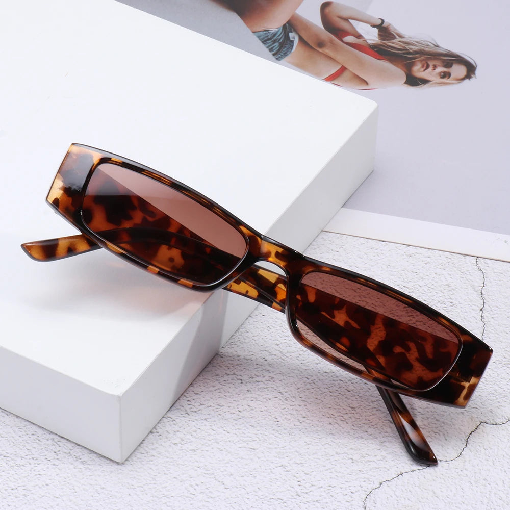 Chic women's slim rectangular sunglasses with UV protection, perfect retro 90s fashion accessory.