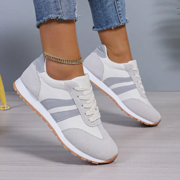 Fashion women's lace-up sneakers featuring retro stripes & colorblock. Blue & gray casual shoes with a vintage street style.