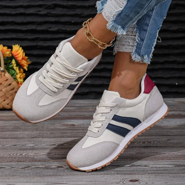 Stylish women's lace-up colorblock sneakers with retro stripes. Casual blue & gray footwear for a vintage-inspired street look.