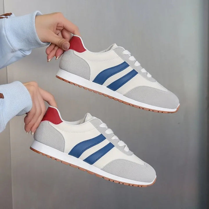 Blue & gray retro women's sneakers. Lace-up colorblock casual shoes, ideal for street style and comfortable everyday fashion.