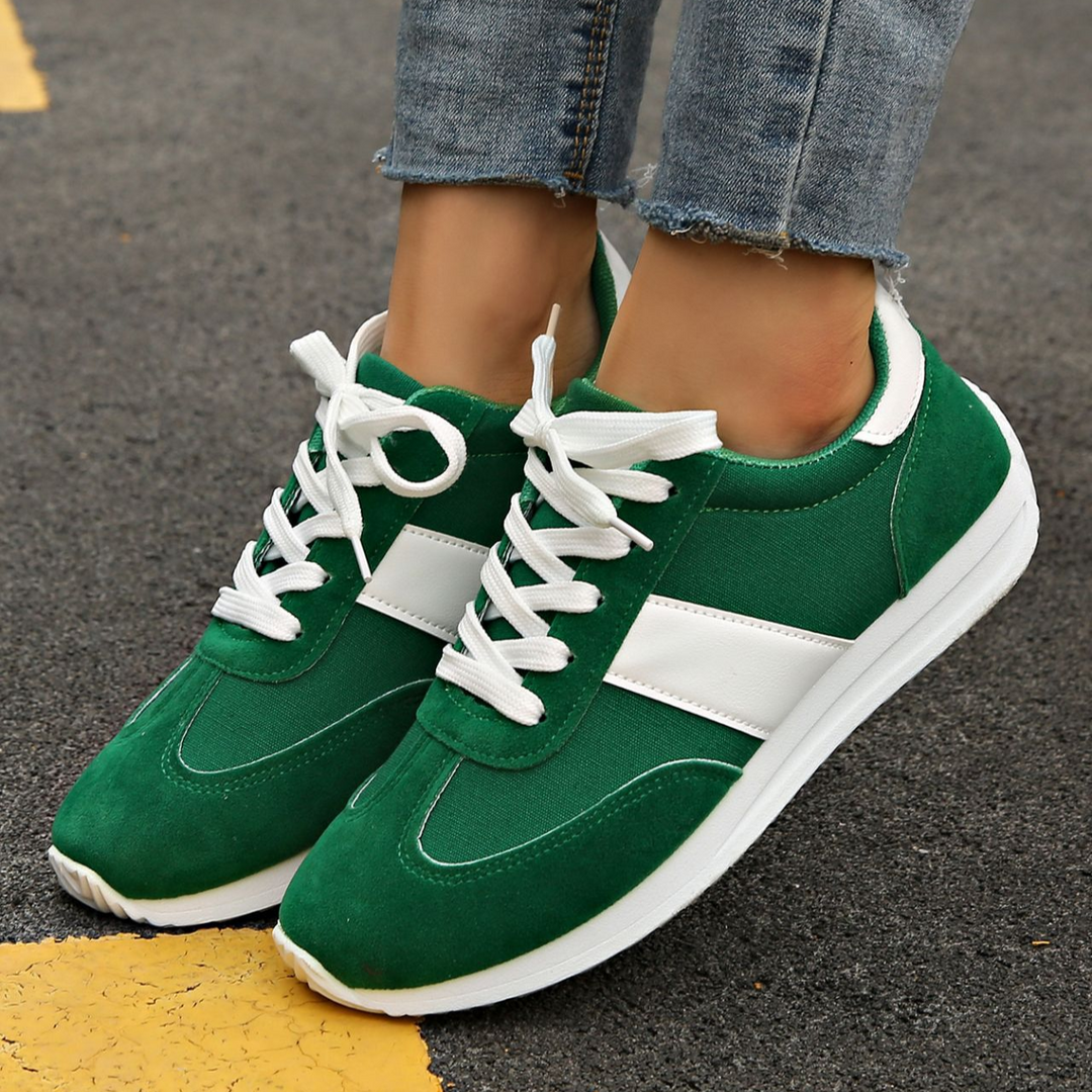 Close-up of women's retro Zippa sneakers, showing textured sole & vintage details for fashion.
