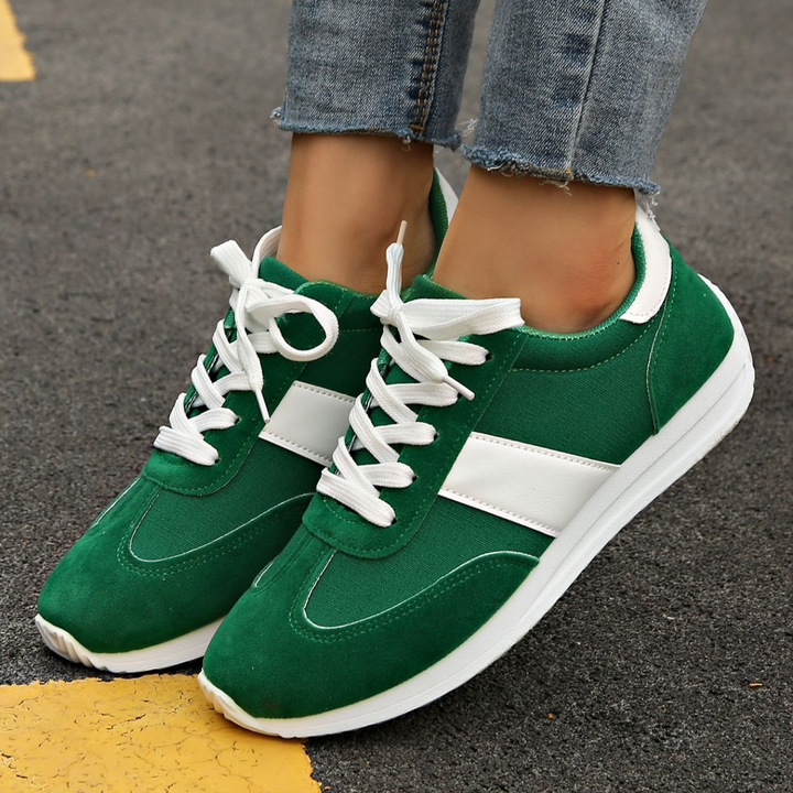 Close-up of women's retro Zippa sneakers, showing textured sole & vintage details for fashion.