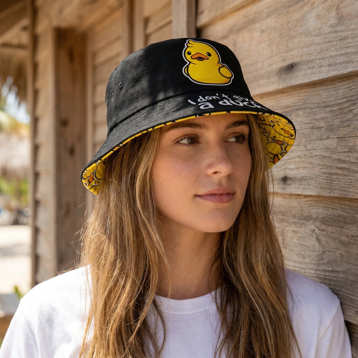 Women's reversible bucket hat with playful duck print on one side & solid color on the other. Casual summer fashion.