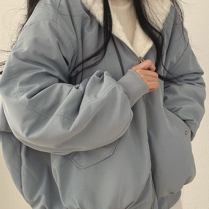 Blue side of women's reversible hooded jacket, cozy outerwear for winter.