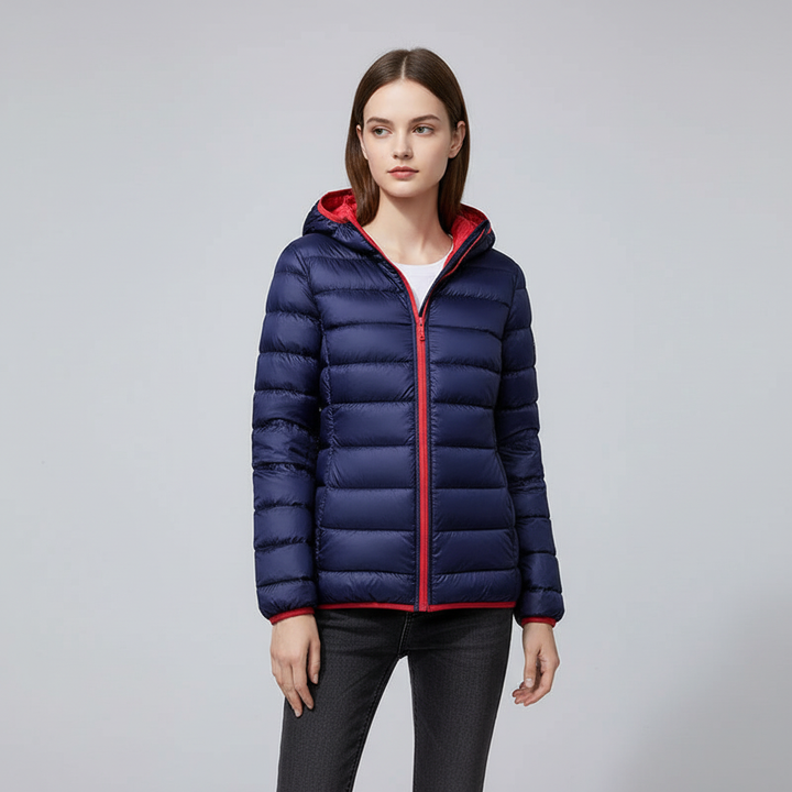 Packable women's winter coat, Nina, in a vibrant blue, showing its compact storage capability.