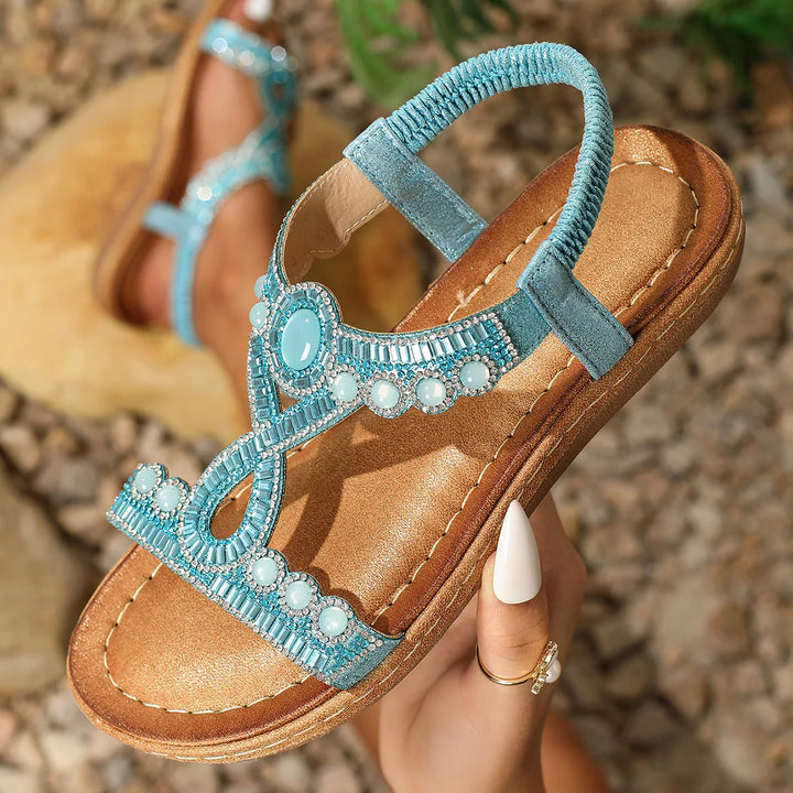 Glamorous women's flat sandals with glitter and rhinestone accents, making them ideal party footwear