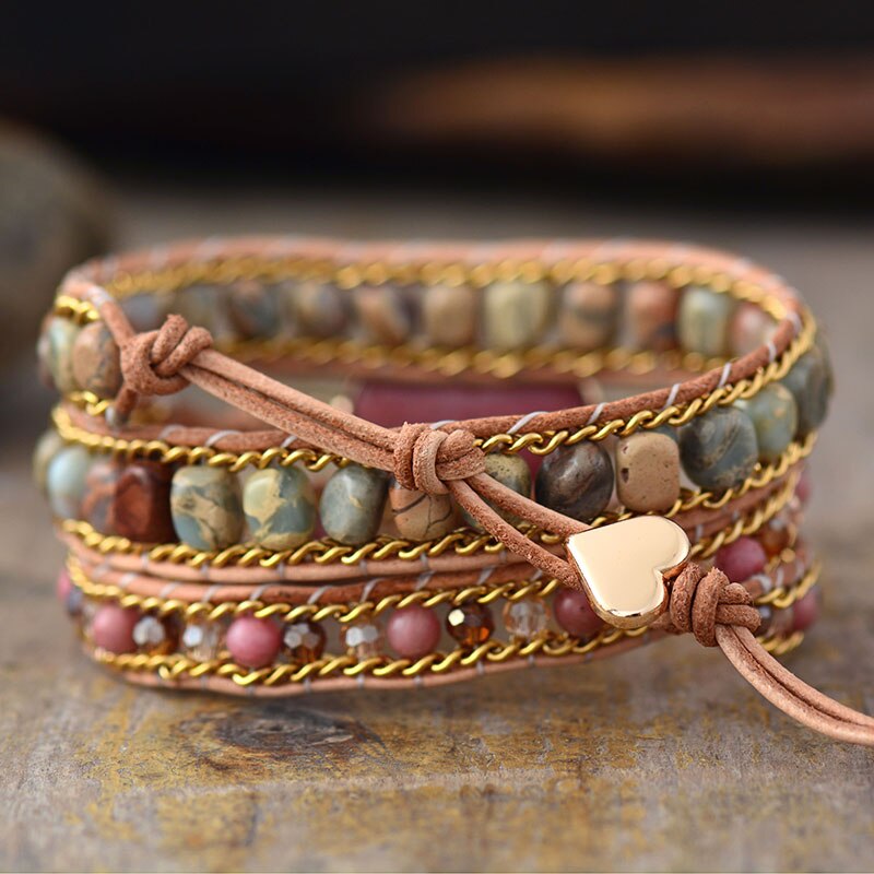 Adjustable women's rhodochrosite heart leather wrap bracelet, a healing stone fashion accessory.