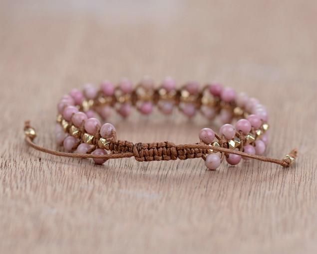 Adjustable Rhodonite Heart Energy bracelet on a woman's wrist, showcasing its delicate design and rhodonite healing crystals