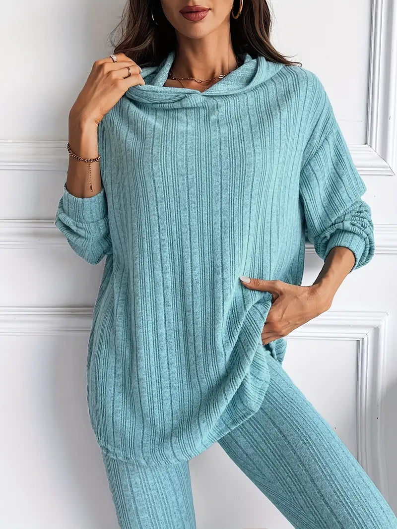 Model wearing a stylish black ribbed knit lounge set. Cozy women's two-piece comfort wear outfit.