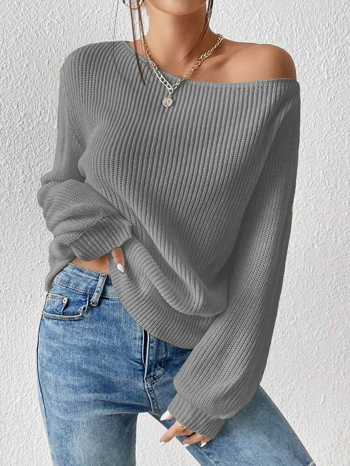 Close-up of a women's ribbed off-shoulder sweater, highlighting the soft texture and stylish long-sleeve design.