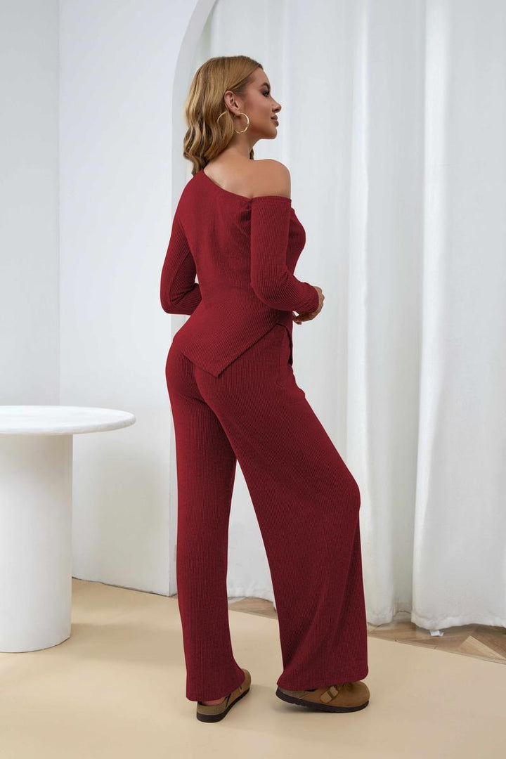 Model wearing a women's ribbed one-shoulder two-piece knit set with wide-leg trousers, elegant and chic.