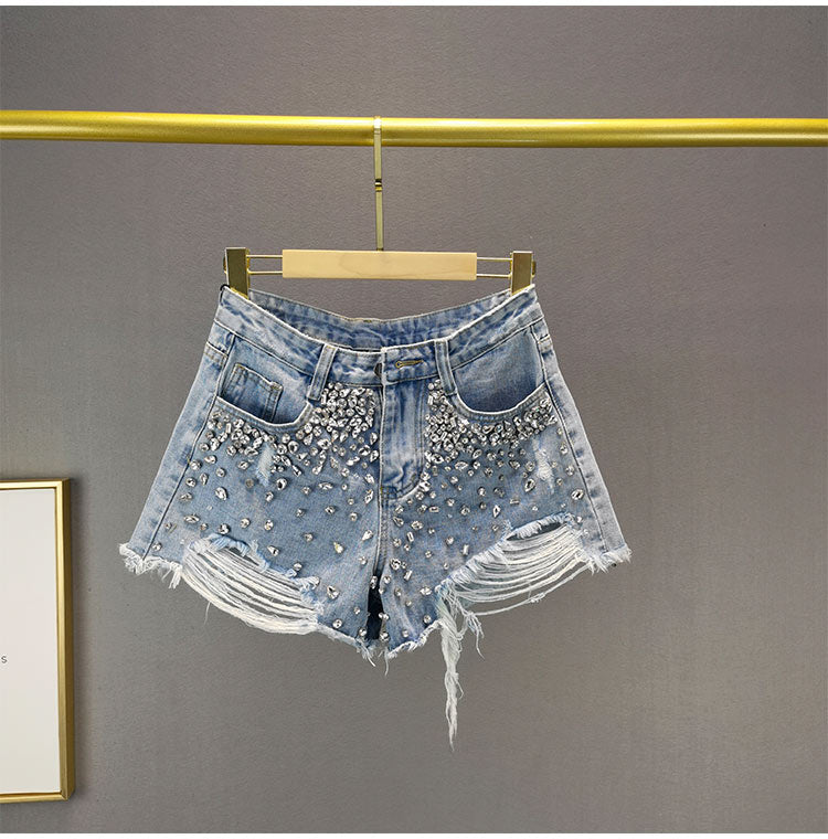 Distressed wide-leg women's shorts with rips for a relaxed, trendy summer look. Comfortable casual high-waist bottoms.