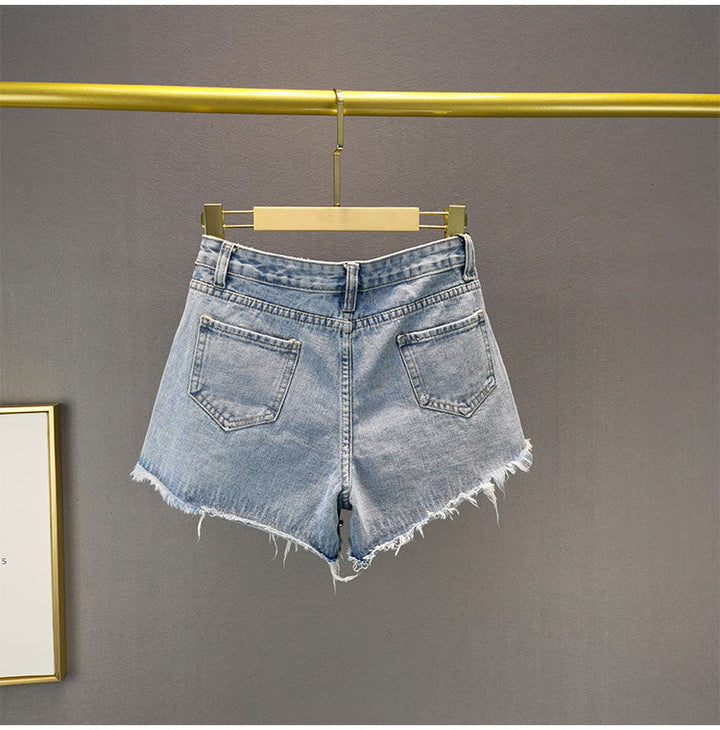 Casual trendy women's ripped wide-leg shorts. Distressed denim bottoms with a relaxed, high-waist fit for summer fashion.