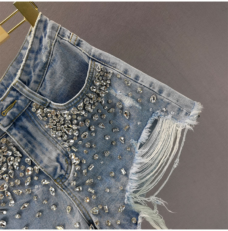 Women's ripped wide-leg shorts in a distressed denim style. High-waist, relaxed fit, trendy casual bottoms for summer.