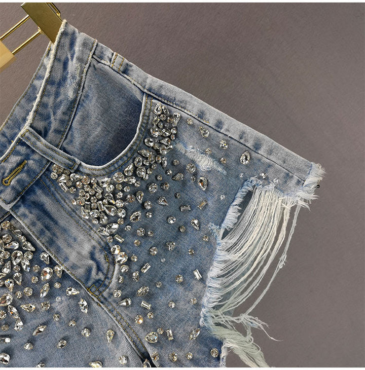 Women's ripped wide-leg shorts in a distressed denim style. High-waist, relaxed fit, trendy casual bottoms for summer.