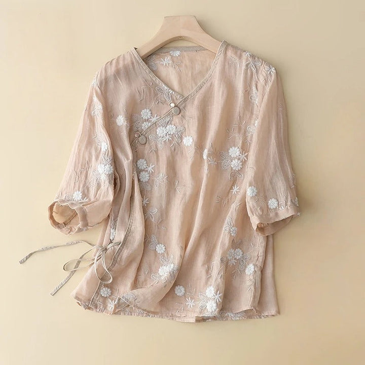 Elegant women's embroidered summer top featuring intricate botanical details and a flowing romantic design.
