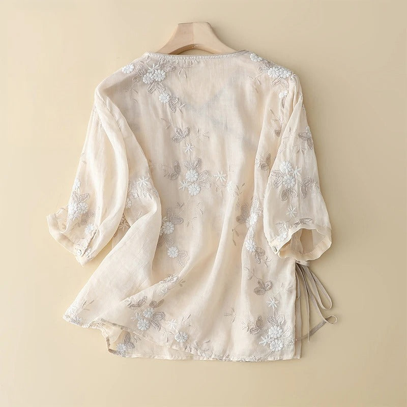 Delicate embroidered women's blouse, ideal for spring fashion. Features a flowing, romantic design for casual chic elegance.