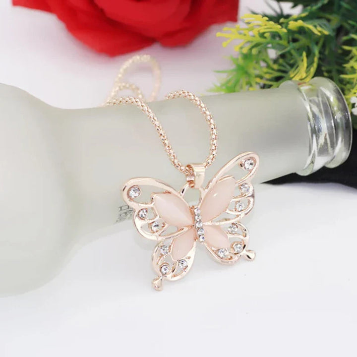 Women's rose gold necklace with a delicate opal butterfly pendant, perfect elegant accessory.