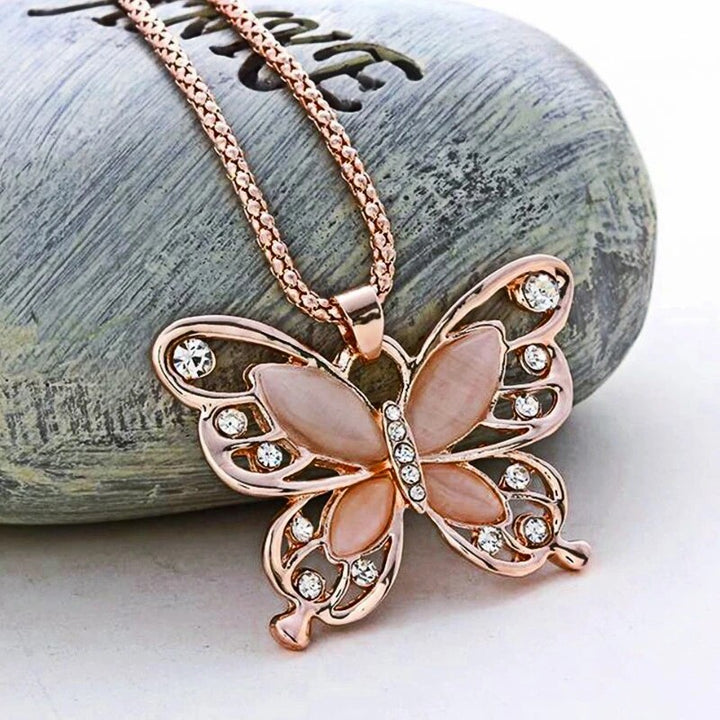 Elegant rose gold necklace featuring a shimmering opal butterfly charm, a beautiful gemstone jewelry piece.