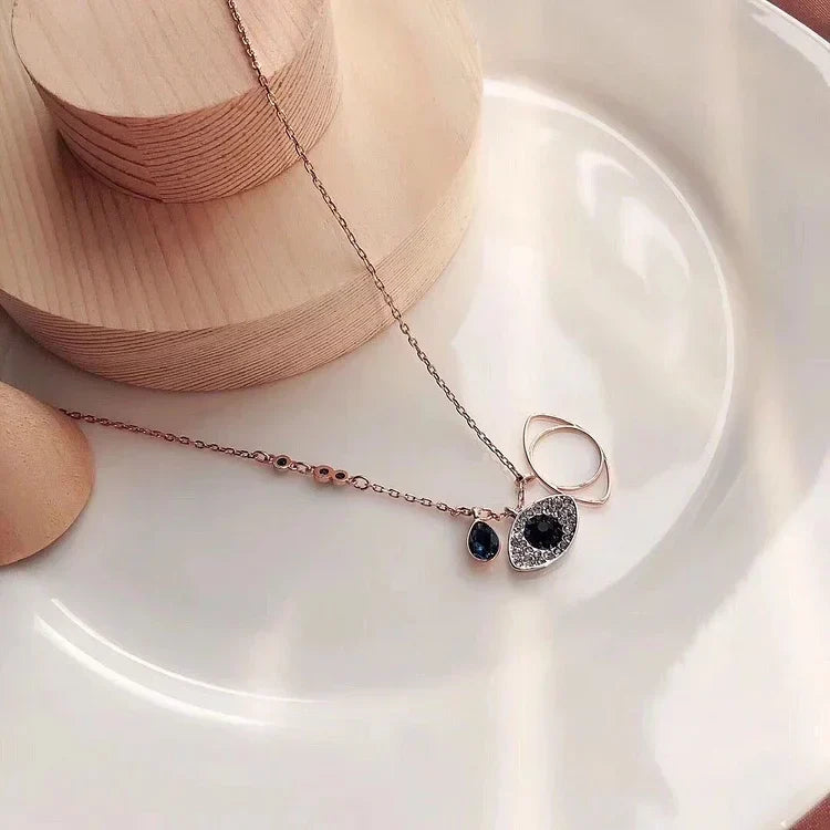 Close-up of a women's Evil Eye necklace & bracelet set in rose gold, designed for protection.