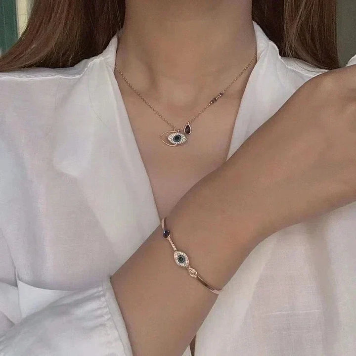 Elegant women's rose gold Evil Eye necklace & bracelet set, a fashionable protection jewelry gift.