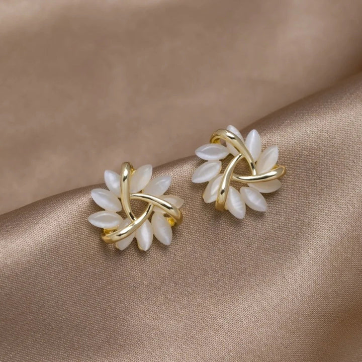 Dainty silver flower stud earrings for women, featuring a shimmering round opal gemstone. Elegant gift idea.