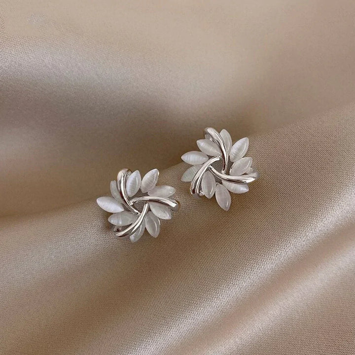 Exquisite women's flower stud earrings with a central round opal, a delicate and elegant jewelry piece.