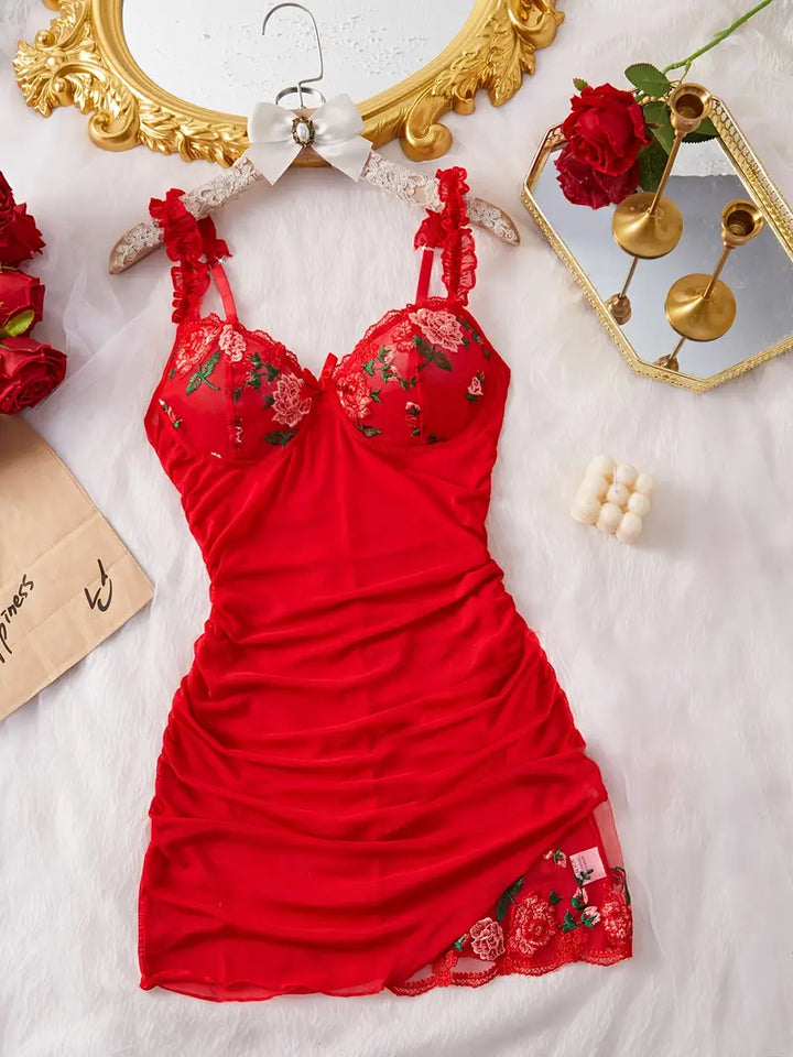 Detailed shot of the ruched fabric and floral embroidery on a women's mesh nightgown.