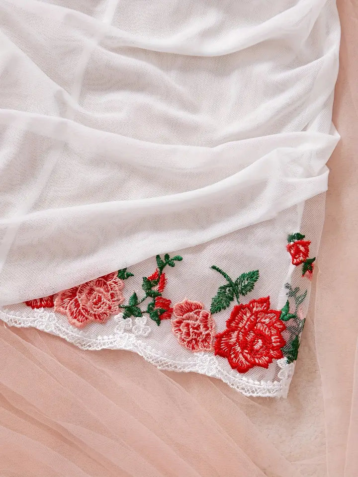 Delicate sheer mesh nightgown for women, enhanced with flattering ruching and floral embroidery.
