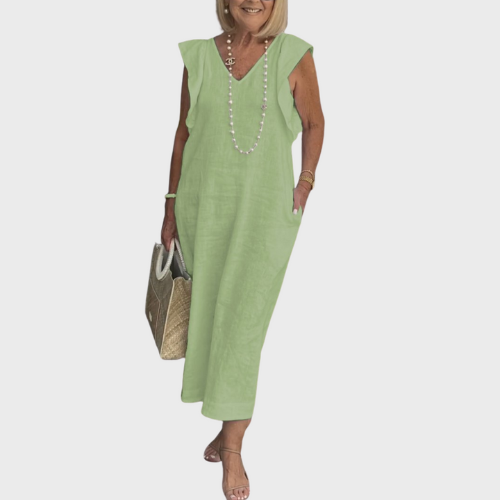 Stylish women's maxi dress: V-neck, ruffle detail shoulders, sleeveless cut, and convenient pockets.
