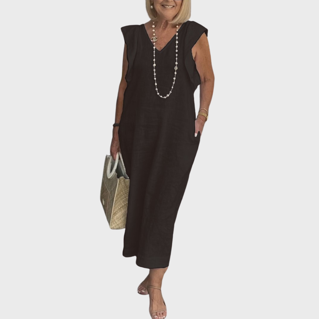 Sleeveless women's maxi dress featuring ruffle shoulders, a V-neckline, and practical side pockets.