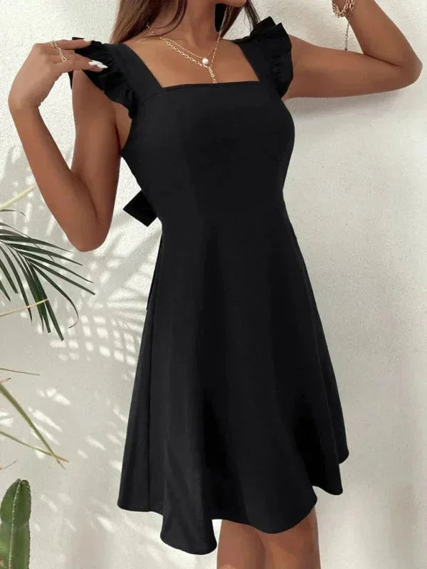 Women's summer A-line mini dress, featuring delicate ruffle straps and a captivating bow back.