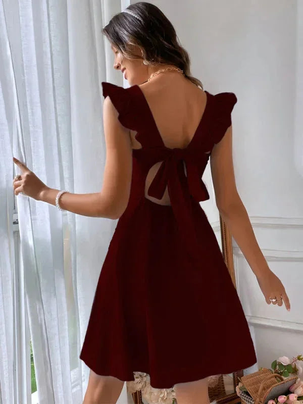 Flirty summer dress for women: A-line mini cut, pretty ruffle straps, and an eye-catching bow back.