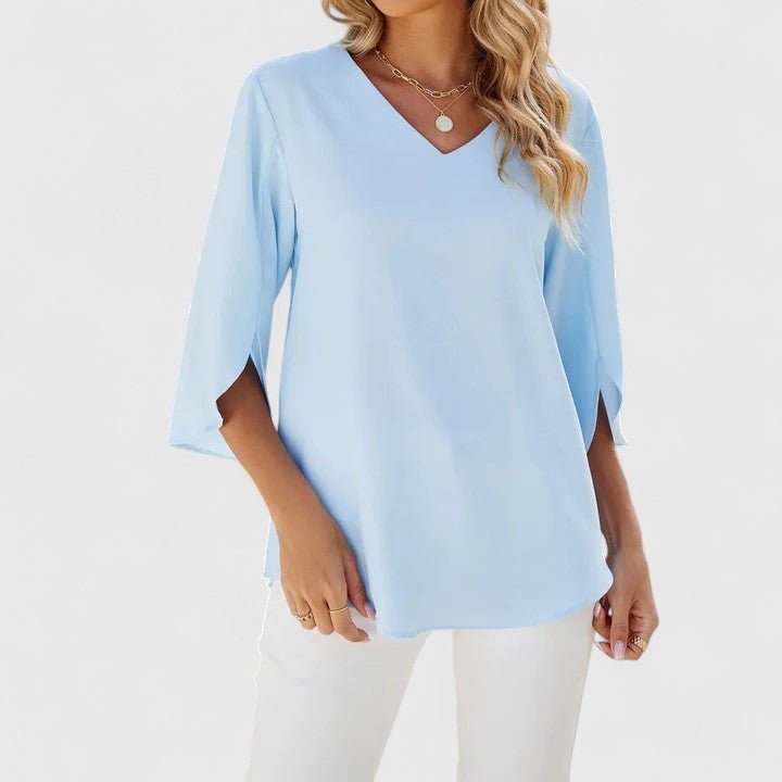 Effortlessly elegant women's V-neck blouse, featuring pretty ruffles & split sleeves, ideal for sophisticated spring fashion.