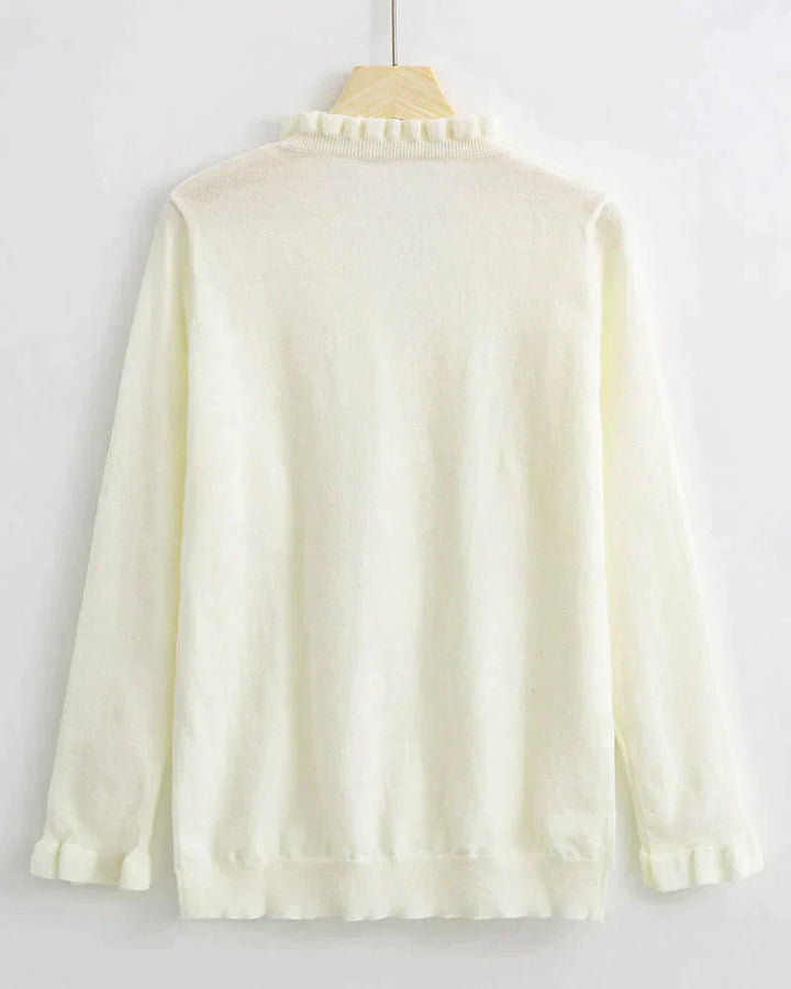 Long sleeve women's ruffled sweater with decorative button details. A fashionable knit top for all-day comfort.