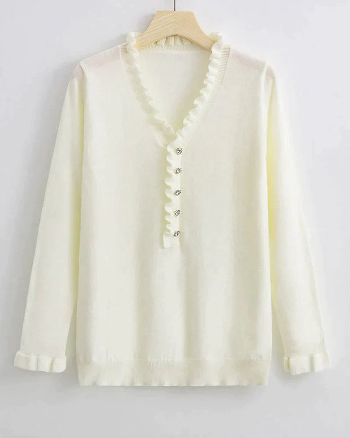 Light blue women's ruffled knit sweater with stylish button details. This cozy top is ideal for casual fashion.
