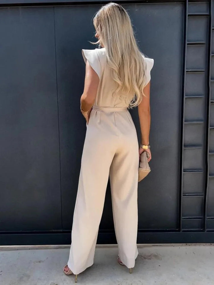 Full-length view of a chic women's wide-leg romper, highlighting the ruffles and elegant tie waist.