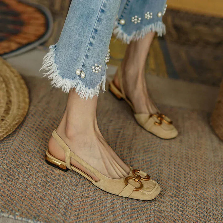 Stylish women's flat sandals with adjustable buckle straps & a comfortable cushioned footbed for daily wear.