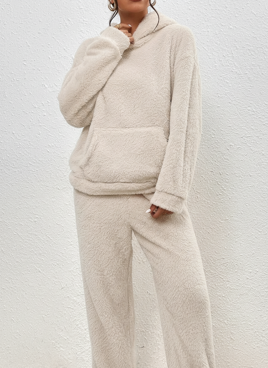 Cozy women's loungewear set, a long hoodie with kangaroo pocket and matching soft trousers, essential winter outfit