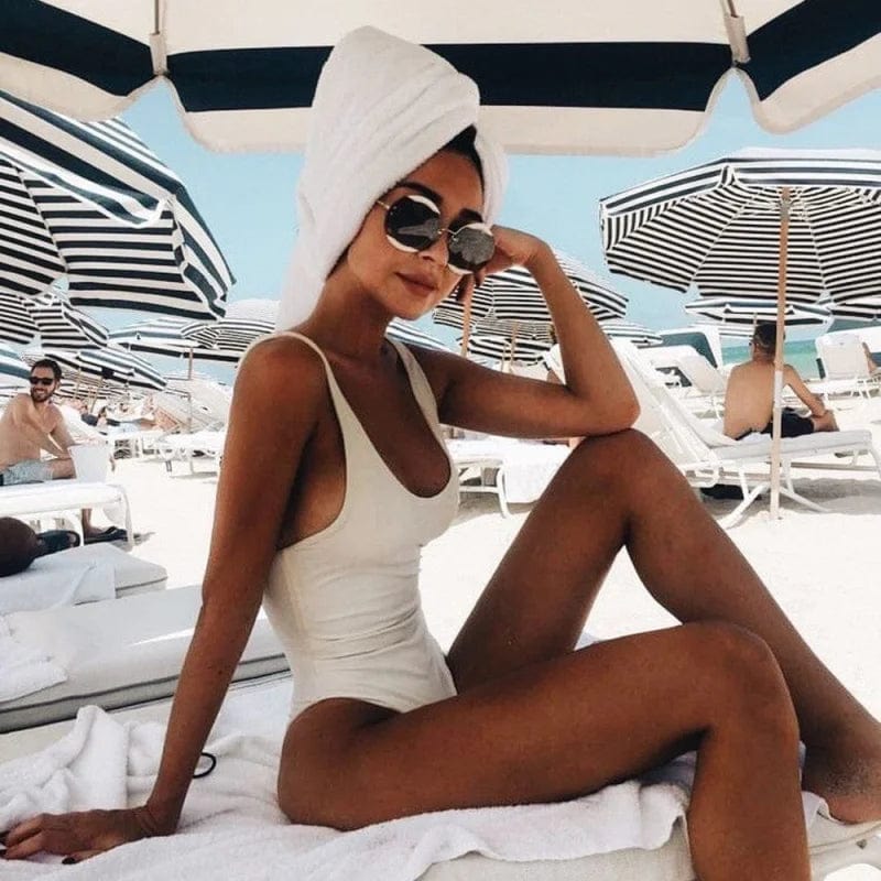 Stylish women's one piece swimsuit featuring a trendy scoop neck and alluring open back design for summer beachwear.