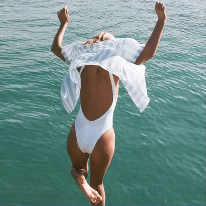 Comfortable women's scoop neck one piece swimsuit with open back, ideal for swimming and sunbathing on vacation.